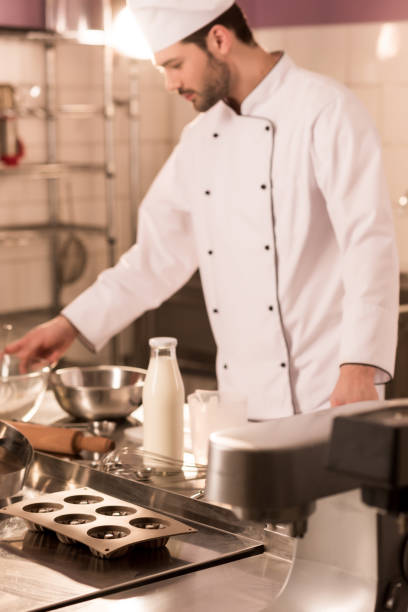 istock selective focus of confectioner standing at counter in restaurant kitchen 922421374
