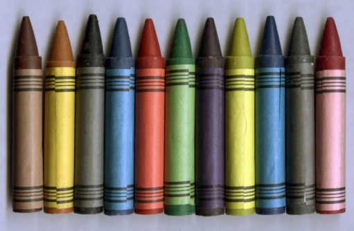 Group multicolored crayons messy and isolated on white background. Crayons of different colors in disorder.