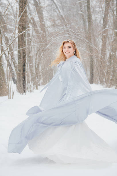 istock Beautiful girl  under the snowfall 922424160