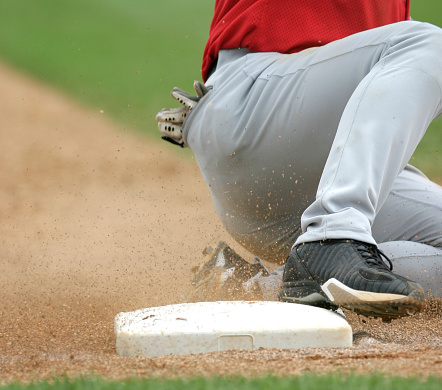 baseball player sliding into base.