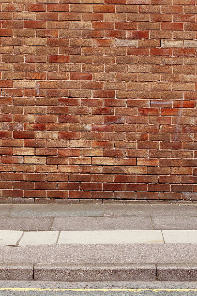 istock Urban background UK - Red brick wall with sidewalk 92242637