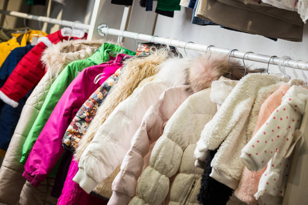 istock baby clothes hang on a shelf in a designer store 922427958