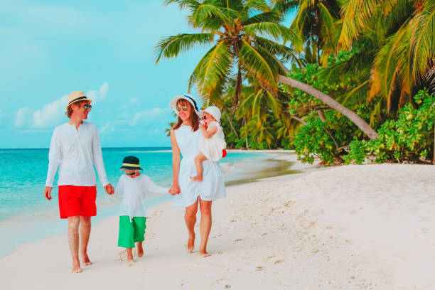 istock happy family with two kids walking on beach 922428262