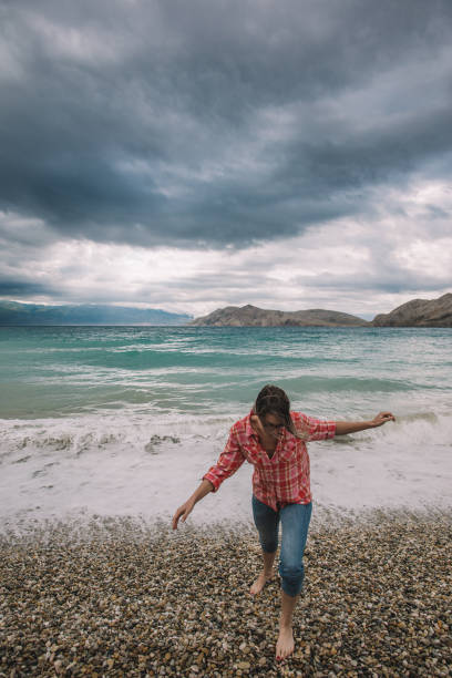 istock Woman walking on beach 922428900