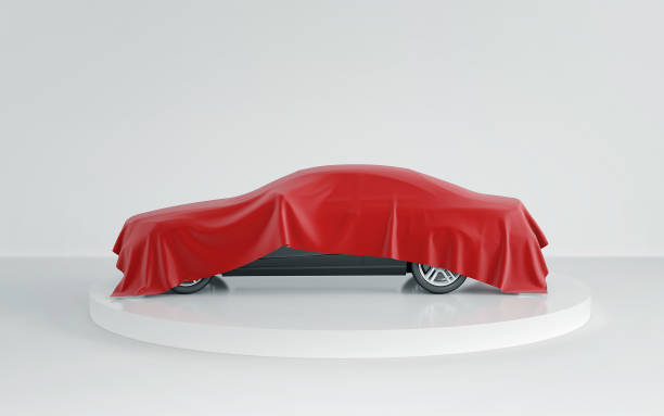 istock New black car hidden under red cover on white background. 3d render 922433768