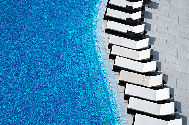 Pool with white sunlounger stock photo