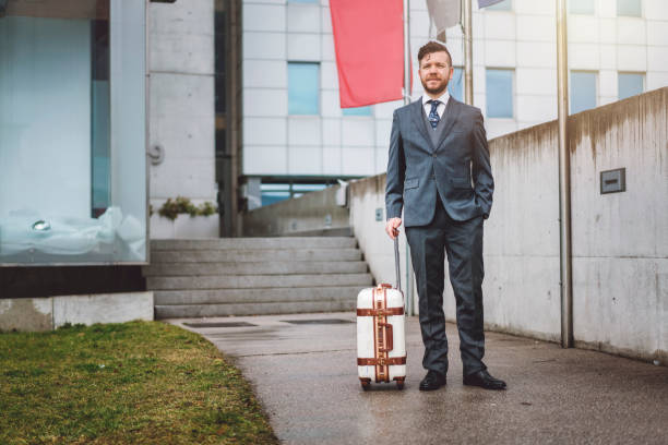 istock One hand in the pocket, one holding the suitcase 922440440