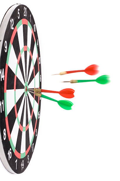 Darts hit the Dartboard stock photo