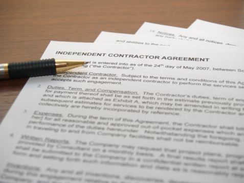 Independent Contractor Agreement Document with a pen to sign