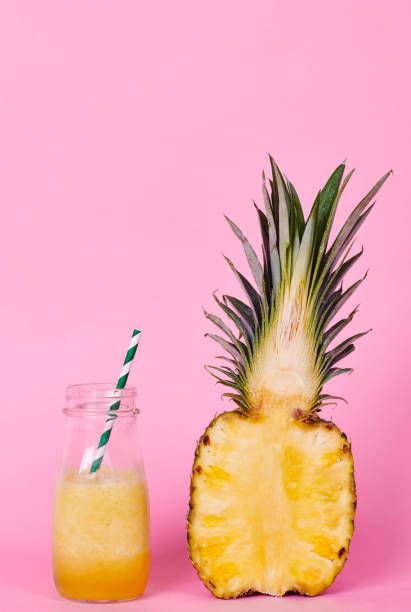 istock Halved pineapple and yellow smoothie at studio shot 922448146