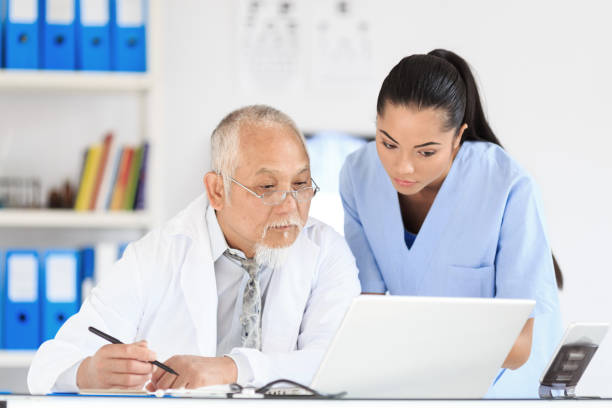 istock Nurse and doctor using laptop in cabinet 922448182