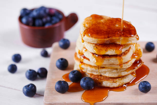 istock Pancakes with honey and blueberry on cutting board 922448658