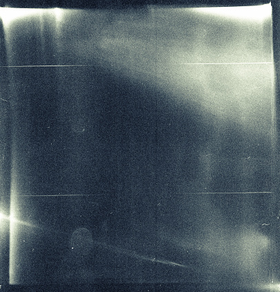 Medium format film frame with heavy scratches, dust and grain