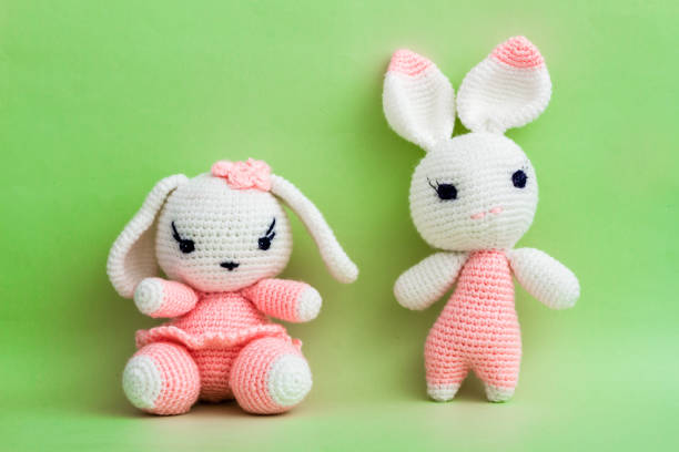 istock Handmade Crochet Rabbit Toys on Green Background. 922476046