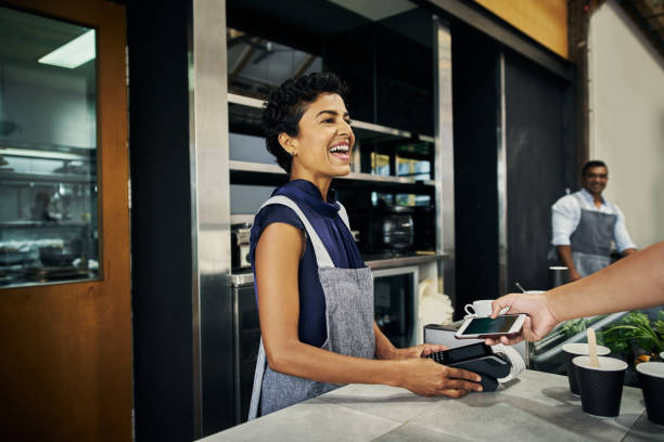 the new convenient way to pay - coffee serving cafeteria worker checkout counter imagens e fotografias de stock