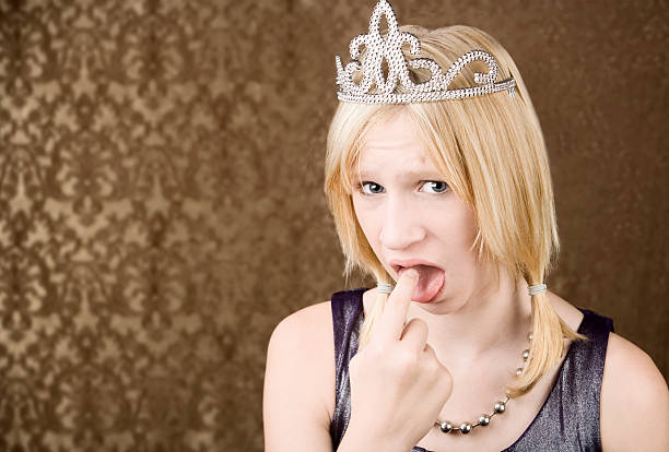 istock Pretty young girl with a tiara showing disgust 92248514