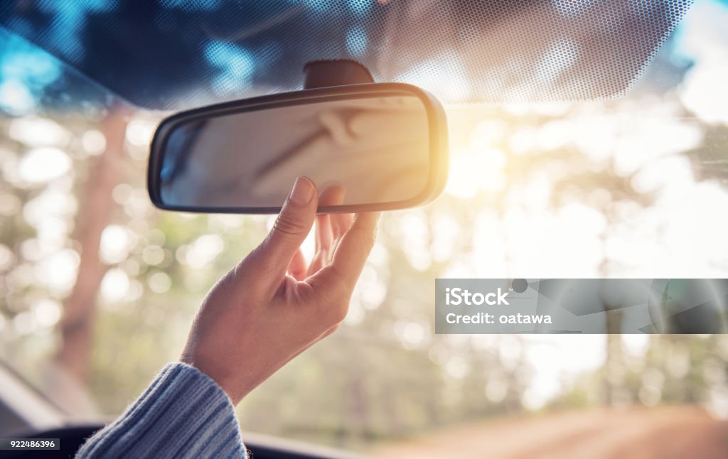 Hand adjusting rear view mirror. Safety concept. Close up Hand adjusting rear view mirror. Safety concept. Rear-View Mirror Stock Photo