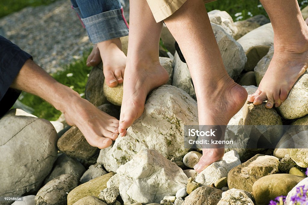 Healthy feet: on the stones Healthy feet series: legs of men and women of different ages on stones Adult Stock Photo