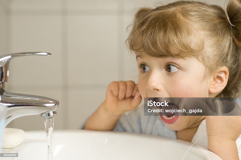 Cute girl cleaning teeth by floss  Dental Floss Stock Photo