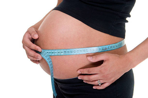 istock Measuring Tape Around Pregnant Woman's Belly 92249475