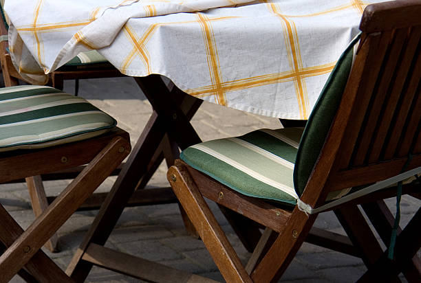 istock summer caffe - wooden chairs and table outdoors 92249628