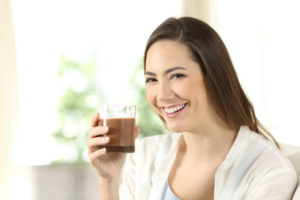 istock Girl holding a cocoa shake looking at you 922496312