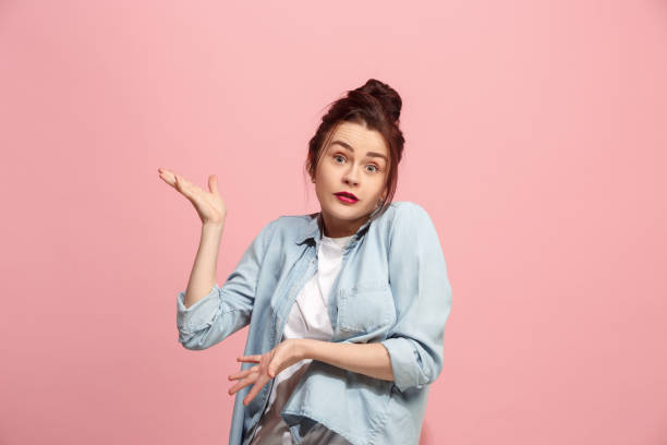 istock Beautiful woman looking suprised and bewildered isolated on pink 922496514