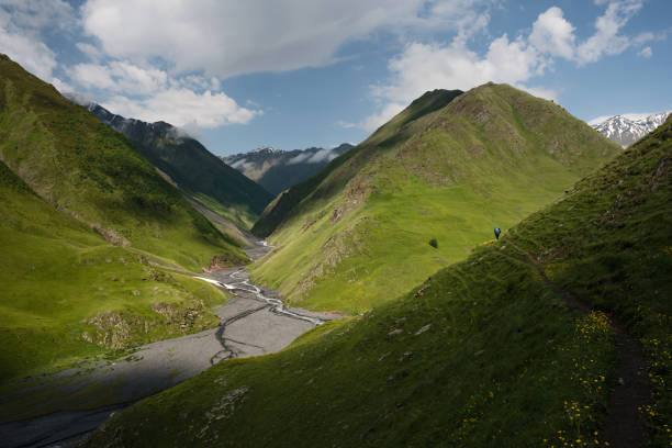 istock Landscape of a mountain valley with view at mountain river and mountain range. 922499084