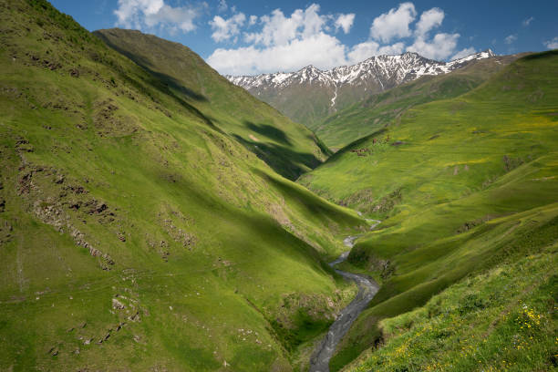 istock Landscape of a mountain valley with view at mountain river and mountain range. 922499088