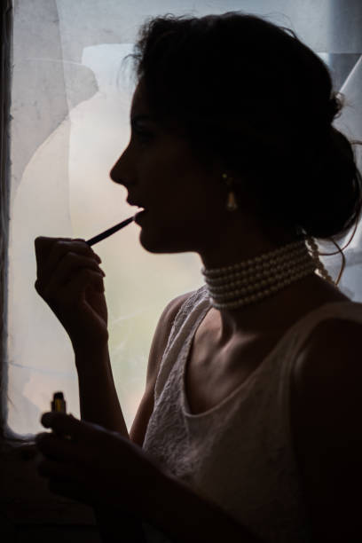 istock Close up of female face applying lip gloss 922505458