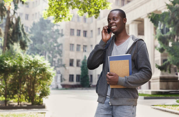 istock Happy african-american student talking on smartphone in campus 922505946