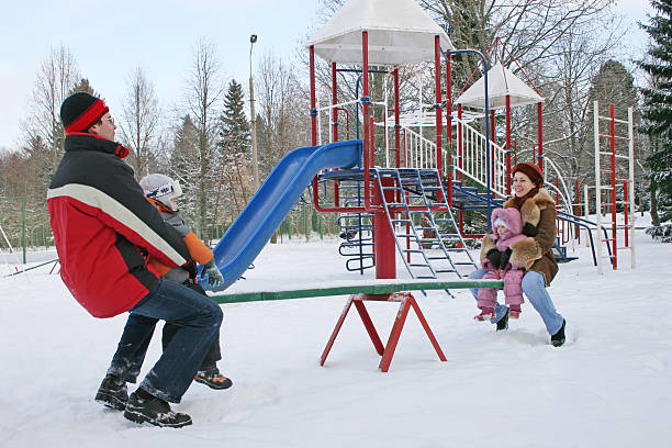 istock winter family on seesaw 92250621