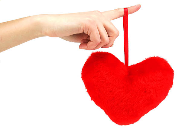 istock Red wooden heart hanging down from female hand 92250732