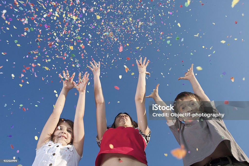 happiness smiling children and young girl throw up confetti Adult Stock Photo