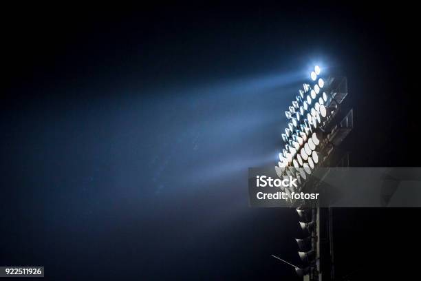 Light Tower Lit At A Stadium During Nightime Stock Photo - Download Image Now - American Football - Sport, Floodlight, Soccer