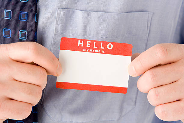 крупный план бизнесмен присоединения именная табличка - hello identity name tag greeting стоковые фото и изображения