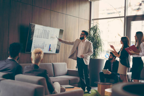 Business presentation Business team on a morning briefing; business meeting and presentation in a modern office b2b sales stock pictures, royalty-free photos & images