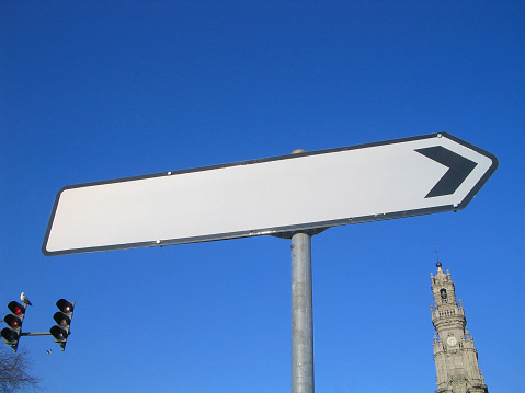 Blank sign in Oporto downtown near the city's greatest landmark - Torre dos Clérigos