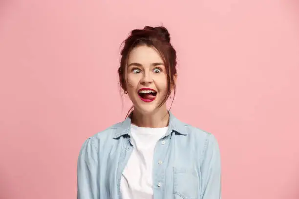 Photo of The squint eyed woman with weird expression isolated on pink