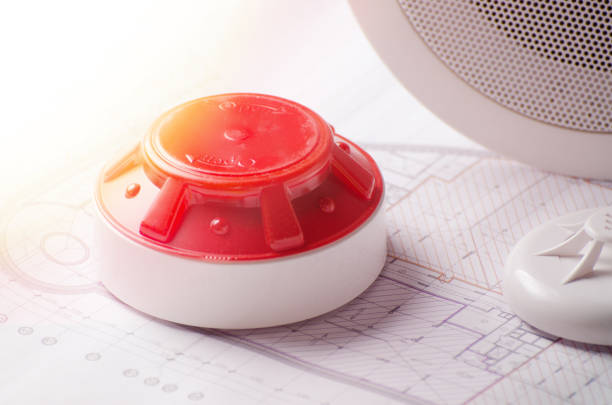 istock Fire security equipment and blueprint on a table. Good for security servise engeniering company site 922526618