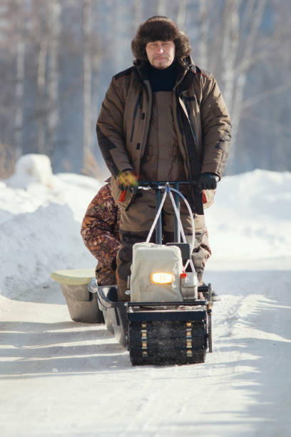 istock Compact snowmobile for hunting - motorcycle towing pulls cargo on snow countryside 922527802