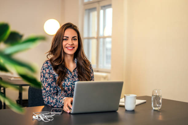 istock Woman in bright modern office working on laptop. 922530230