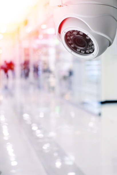 istock Cctv camera security system on a ceiling of a shopping mall blurred background. 922531306