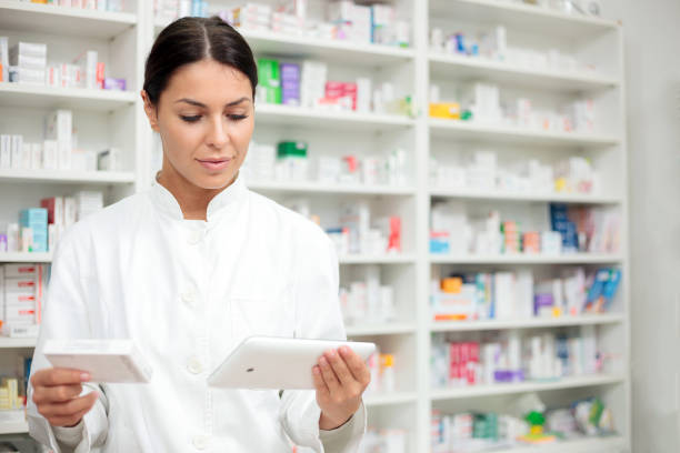 istock Beautiful young pharmacist checking medication details on a digital tablet 922531608