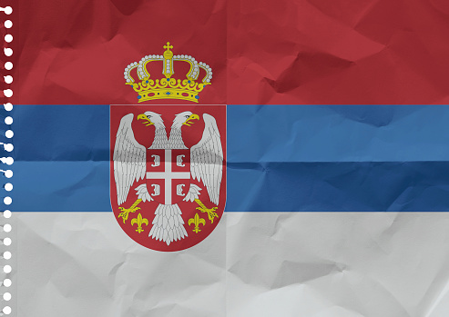 Serbian flag on a sheet of paper torn out from a notebook.