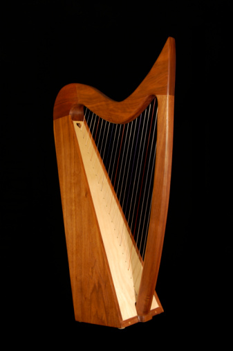 Hand-made Irish harp isolated on black.