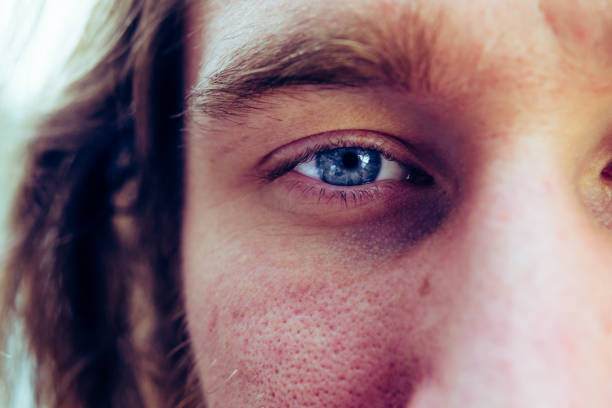 istock Extreme close-up of a human face with blue eye in sharp focus 922534052