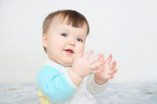 istock happy smiling clapping hands cute baby, blue eyes cheerful infant playing funny 922535668