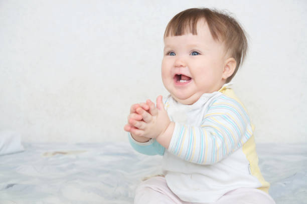 istock happy smiling clapping hands cute baby, blue eyes cheerful infant playing funny 922535856