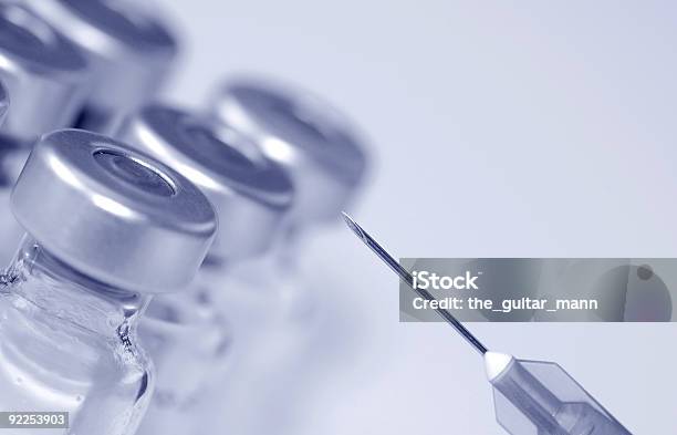 A Needle Prepped To Get Vaccinations Out Of The Bottle Stock Photo - Download Image Now